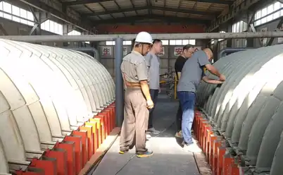 Personnel examining ceramic filter discs at the Tongbai project site
